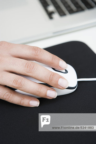 Diessen am Ammersee  Close up of woman's hand on mouse with mousepad