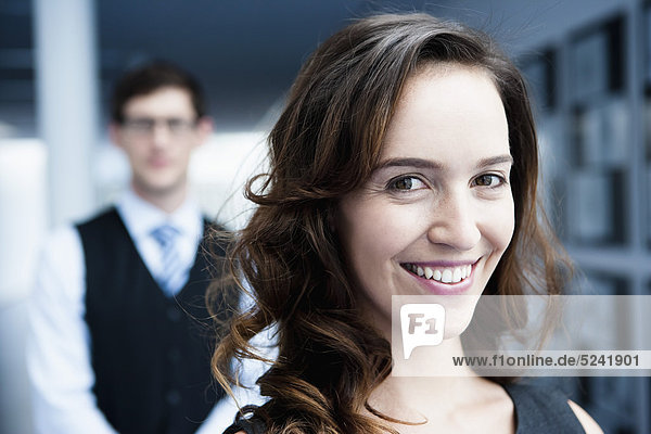 Diessen am Ammersee  Close up of businesswoman standing in front of businessman  smiling