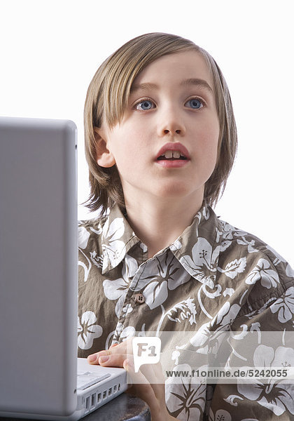 Kleiner Junge an Laptop  Halbporträt