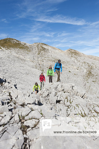 Austria  Kleinwalsertal  Group of people hiking on rocky mountain trail