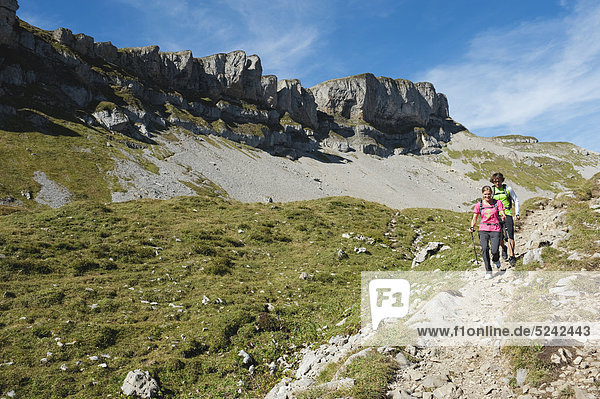 Austria  Kleinwalsertal  Man and woman hiking on mountain trail