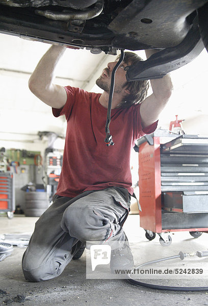 Germany  Ebenhausen  Mechatronic technician working in car garage
