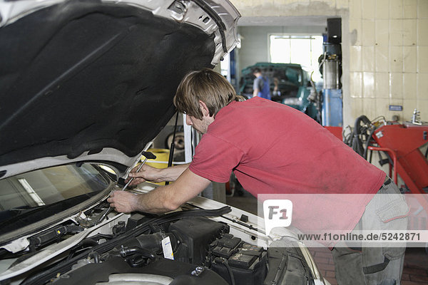 Germany  Ebenhausen  Mechatronic technician working in car garage