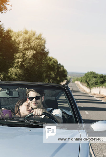 Spain  Majorca  Young couple travelling in cabriolet car