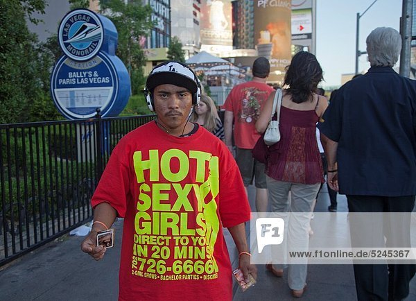 Las Vegas, Nevada - A man hands cards for ´hot sexy girls´ to tourists on  The Strip