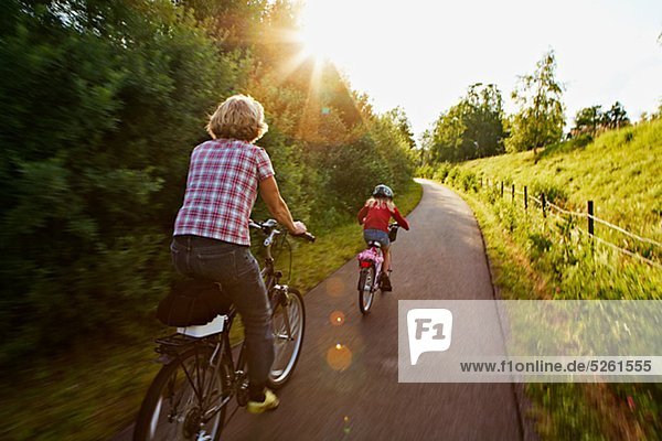 Girl with mother riding bike