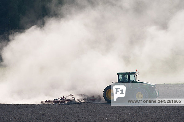 Tractor and dust on field