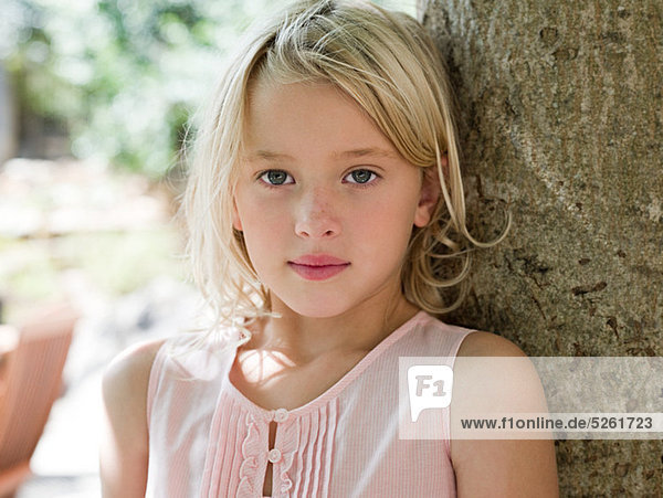 Girl with blonde hair by tree  portrait