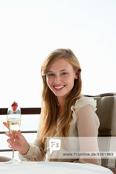 Young Woman Holding Champagne Flöte  portrait