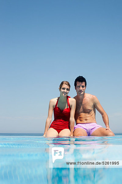 Young couple by swimming pool  portrait