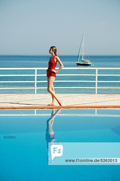 Young woman by swimming pool  portrait