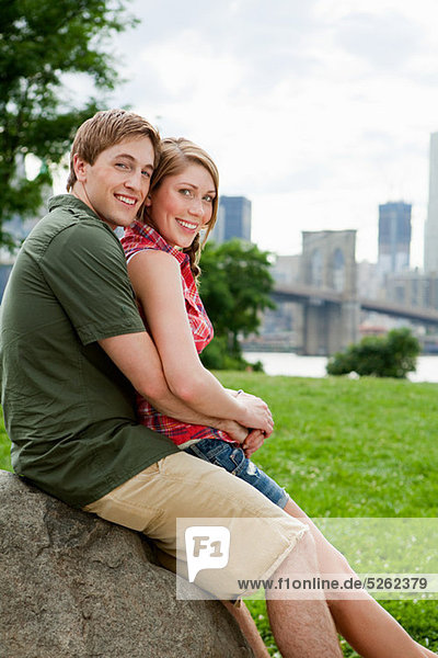 Portrait of young couple in city park