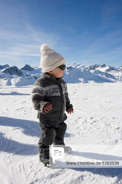 Portrait of boy standing in snow