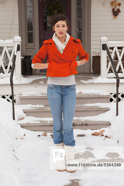 Teenage girl outside house  portrait
