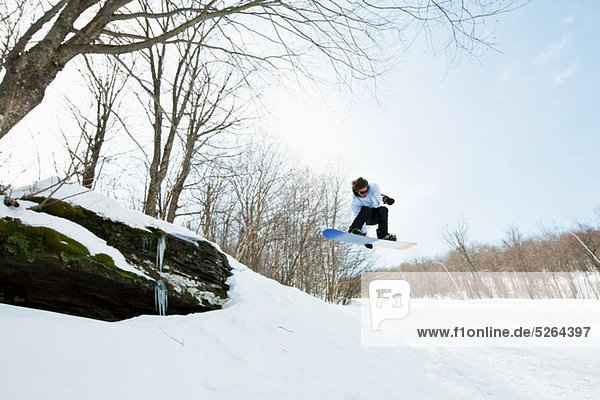 Snowboarder jumping in midair