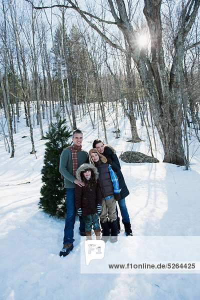 Family standing in snow  portrait