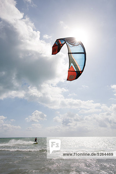 Young man kitesurfing