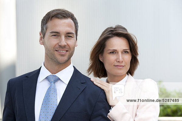 Businesswoman laying her hand on the shoulder of a businessman