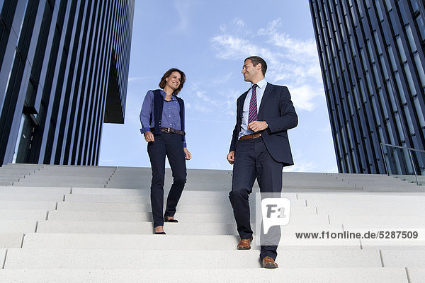 Geschäftsmann und Geschäftsfrau gehen auf einer Treppe