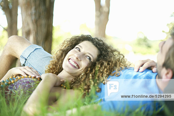 Couple laying in grass together