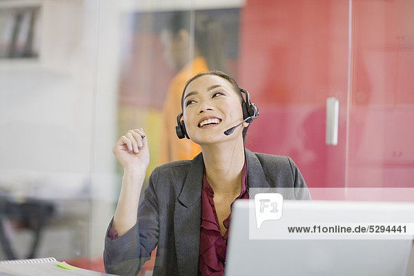 Businesswoman on headset at desk