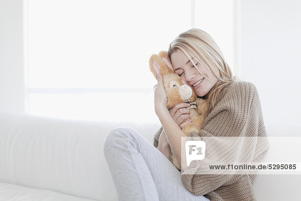 Teenage girl hugging stuffed toy