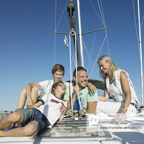 Family relaxing on sailboat