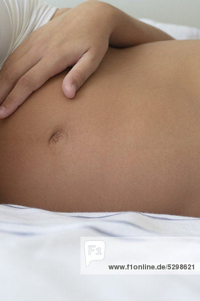 Woman's hand on pregnant belly  cropped