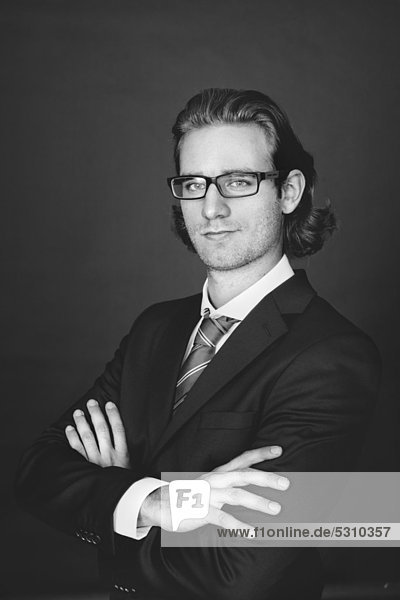 Young man wearing a business suit and glasses  portrait