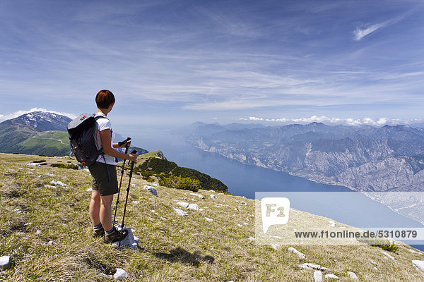 Climber on Monte Altissimo above Nago  looking towards Lake Garda  with Monte Baldo at the rear  Trentino  Italy  Europe