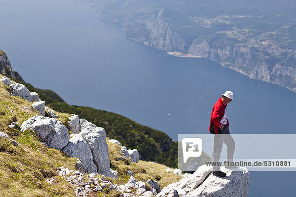 Climber on Monte Altissimo above Nago  looking towards Lake Garda  Trentino  Italy  Europe