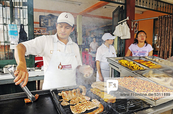 Longanizas sausages  a specialty  being grilled by staff  restaurant in the village of Sutamarchan  Boyaca department  Colombia  South America
