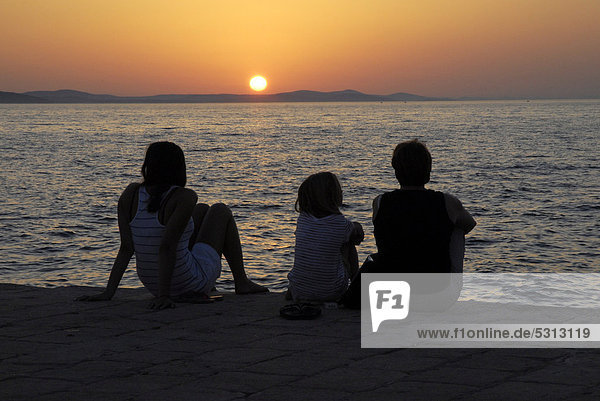 People watching the sunset from a port mole  Zadar  Dalmatia  Adriatic  Croatia  Europe