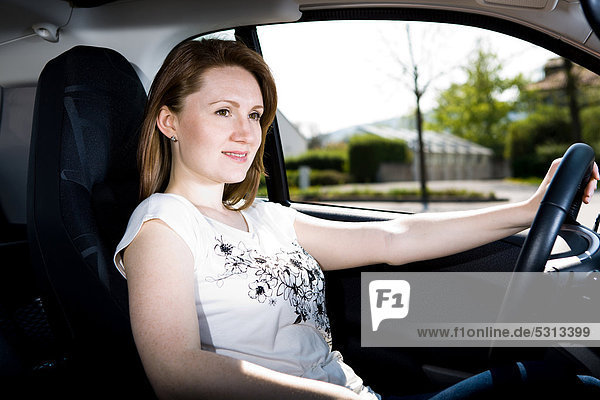 Young woman driving a car