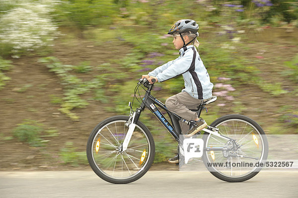 Boy  7 years  riding his bicycle