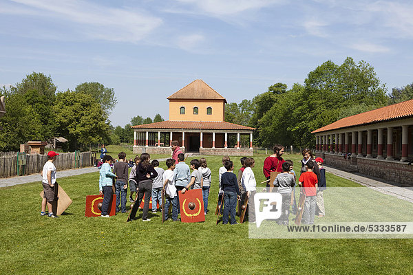 A school class getting lessons in front of a Gallo-Roman temple  Archaeological Site and open-air Museum L'ArchÈosite d'Aubechies  Aubechies  Hainaut  Walloon Region or Wallonia  Belgium  Europe