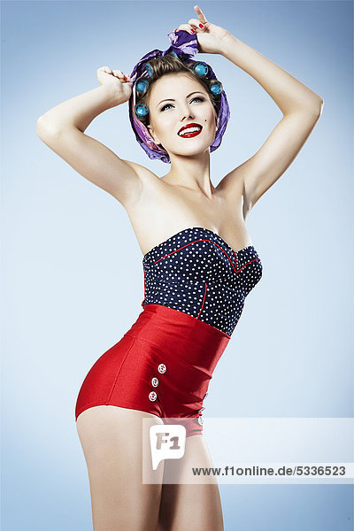 Young woman with hair curlers and hot pants  pin-up