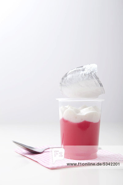 Pink jelly with whipped cream and spoon