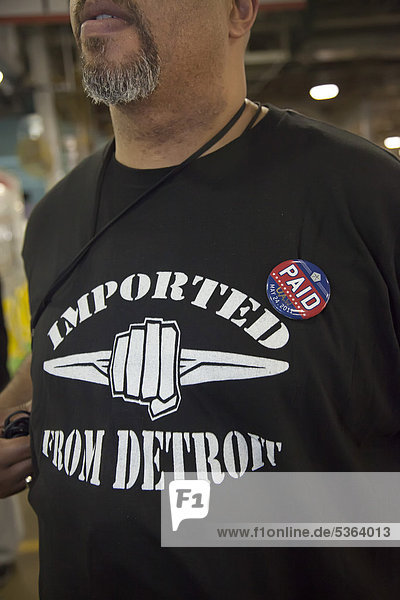 Chrysler marked the repayment of $7.6 billion in loans from the U.S.  Canadian  and Ontario governments with a celebration at the company's Sterling Heights Assembly Plant  here a member of the United Auto Workers union wears a button to mark payment of the loans  Sterling Heights  Michigan  USA
