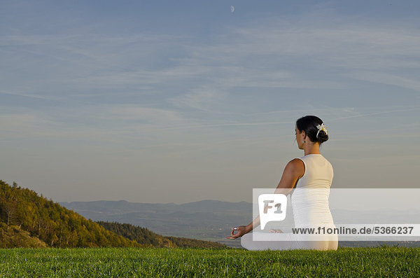 Young woman practising Hatha yoga outdoors  showing the pose padmasana  lotus pose  Nove Mesto  Okres Teplice  Czech Republik  Europe