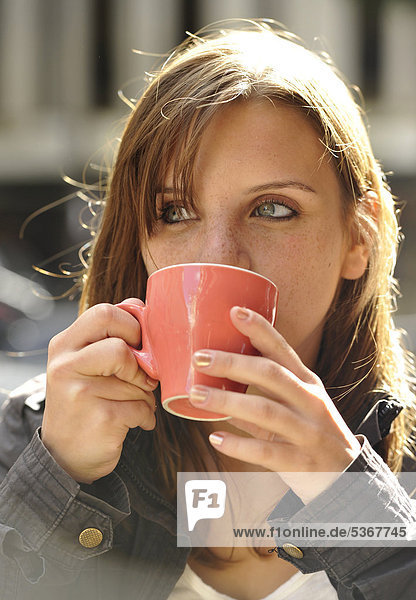Junge Frau trinkt Kaffee  Paris  Frankreich  Europa