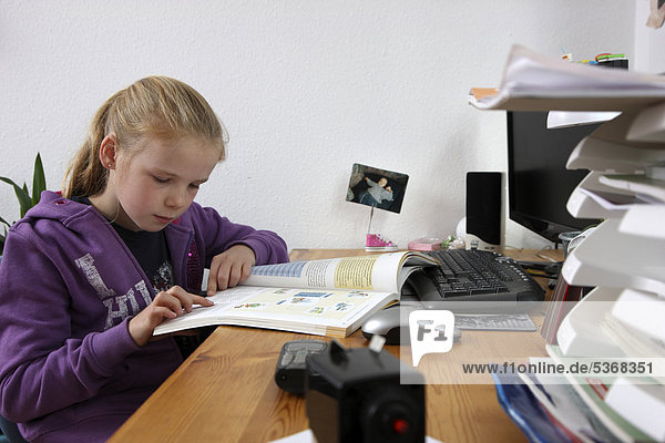 Girl  10 years  doing her homework in her room  studying for school