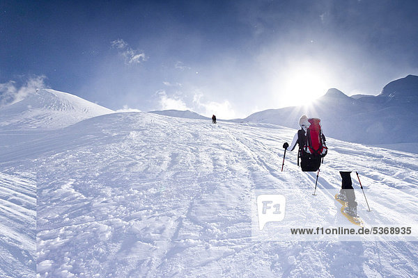 Snowshoe hiker climbing the Kleine Kreuzspitze Mountain in Racines above Sterzing  Alto Adige  Italy  Europe