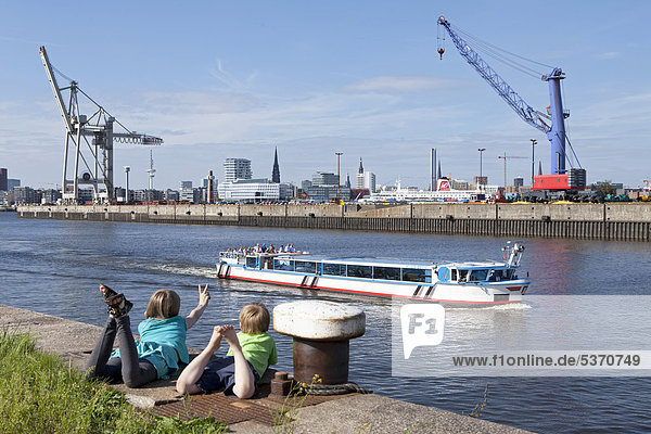 Children watching excursion boat in the harbour  Hamburg Wilhelmsburg  Germany  Europe