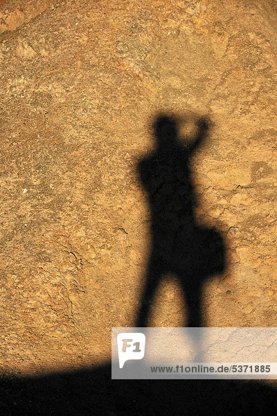 Shadow of a photographer at the Artist's Drive  evening light  Death Valley National Park  Mojave Desert  California  USA