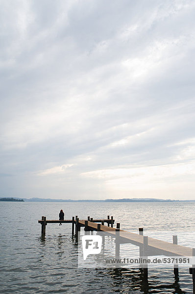 Woman sitting on a jetty