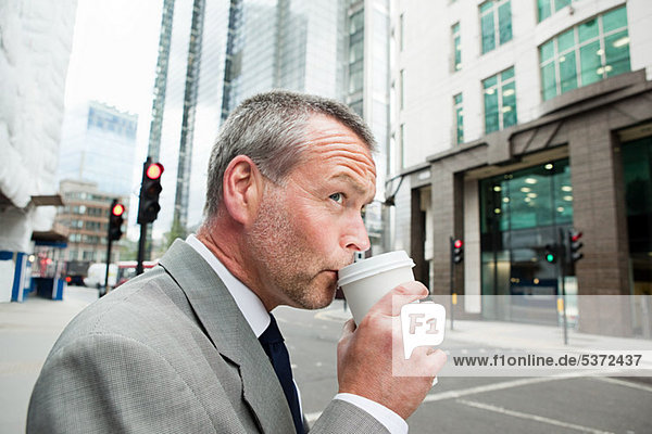 Businessman drinking coffee on the go