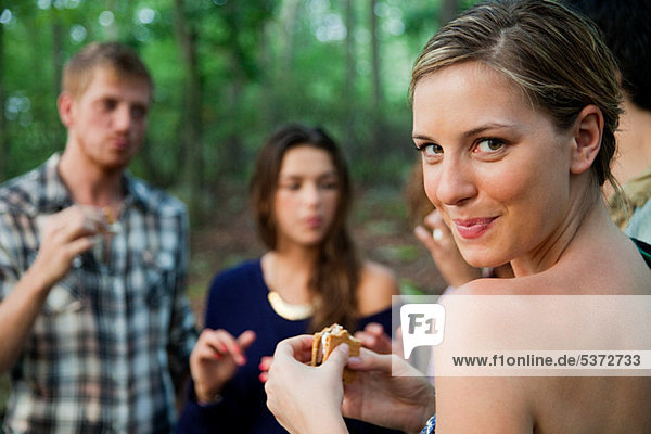 Young woman enjoying food in forest