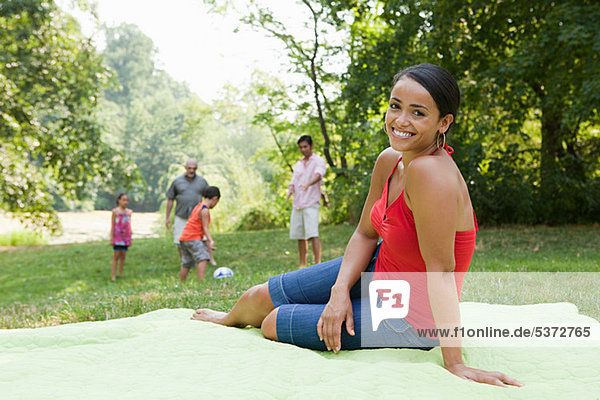 Mid adult woman on blanket in park  portrait