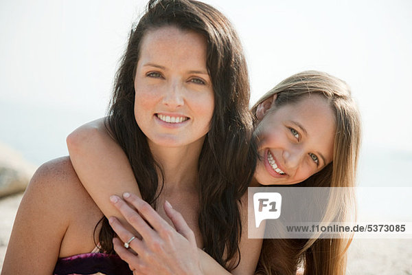 Close up of a mother and daughter embracing